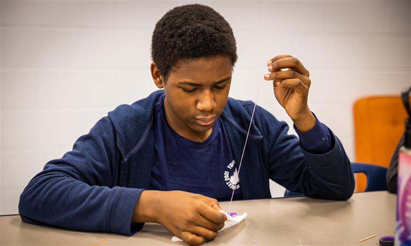 Students practice sewing